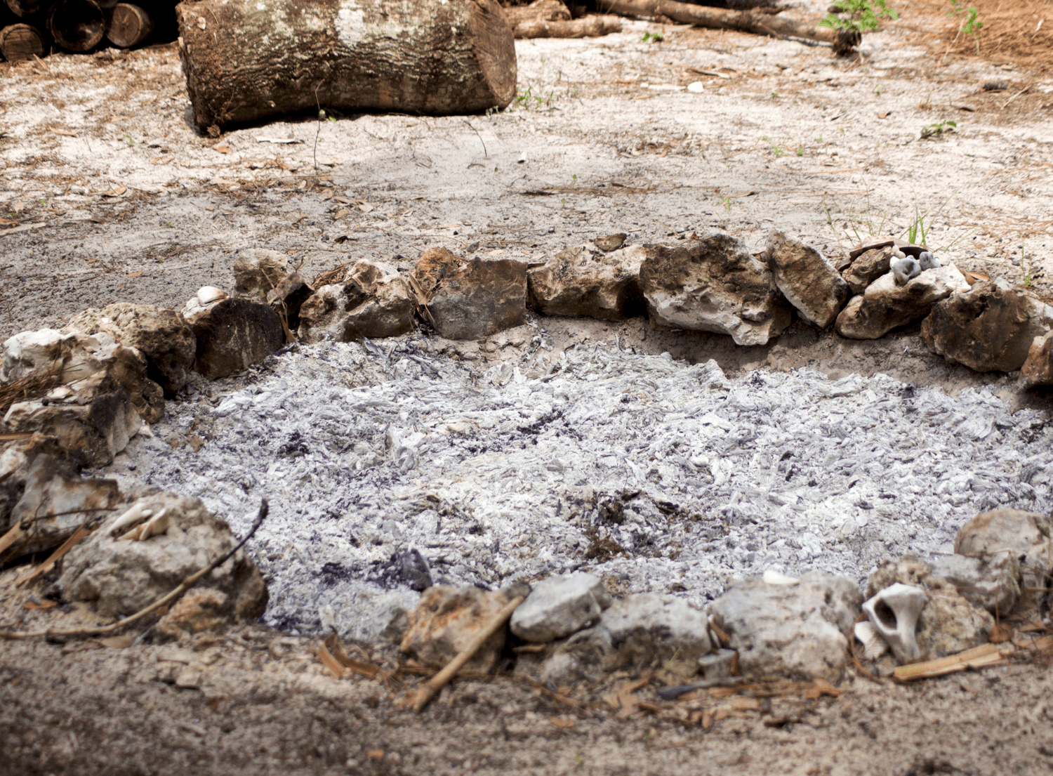 A pit of ash at a campfire - how to dispose of ashes properly