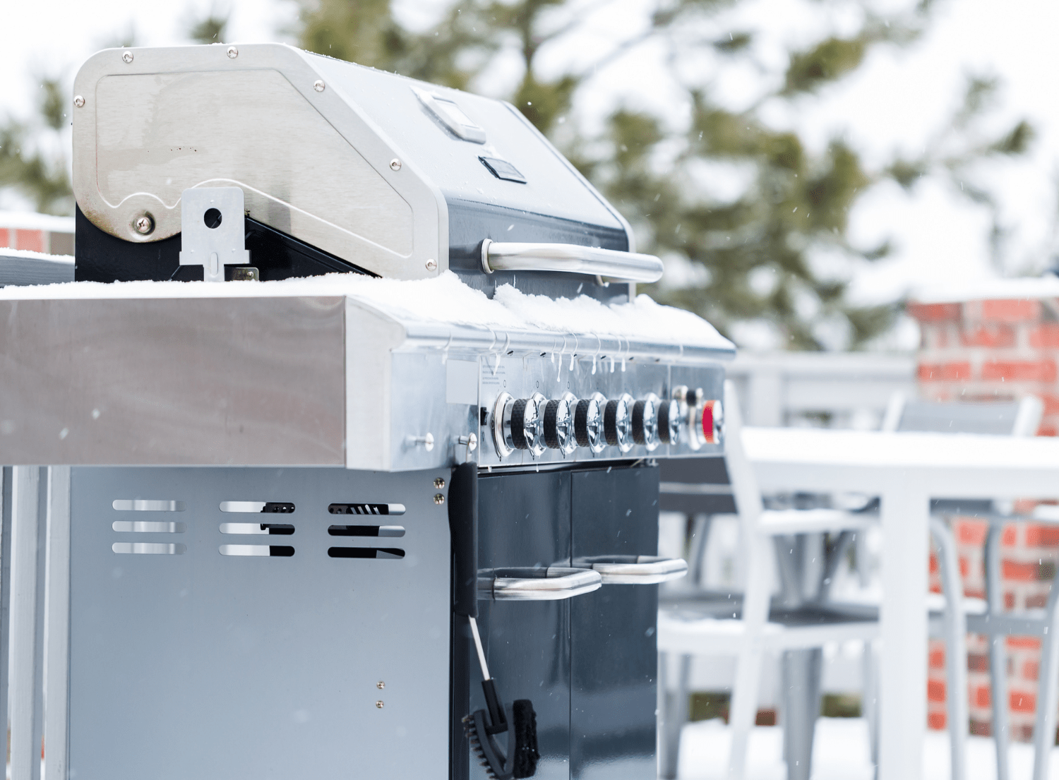 BBQ grill covered in snow and icicles
