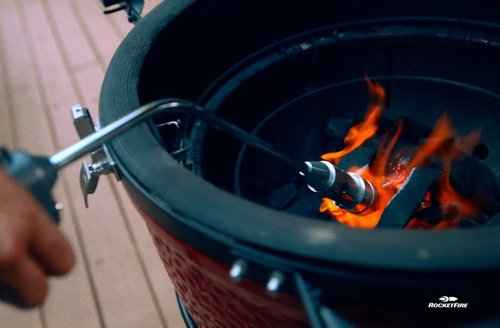 Kamado Joe being lit by RocketFire Torch with fire igniting