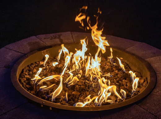 a large fire pit lit during night time