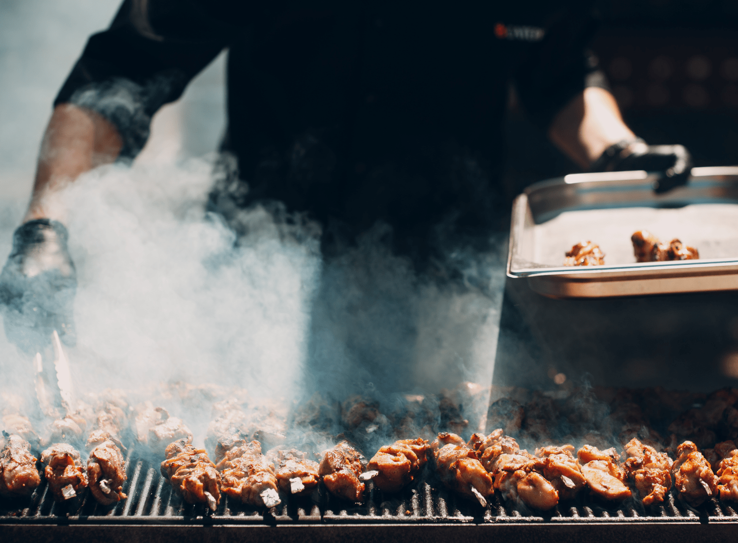 Chef smoking meat on a BBQ grill