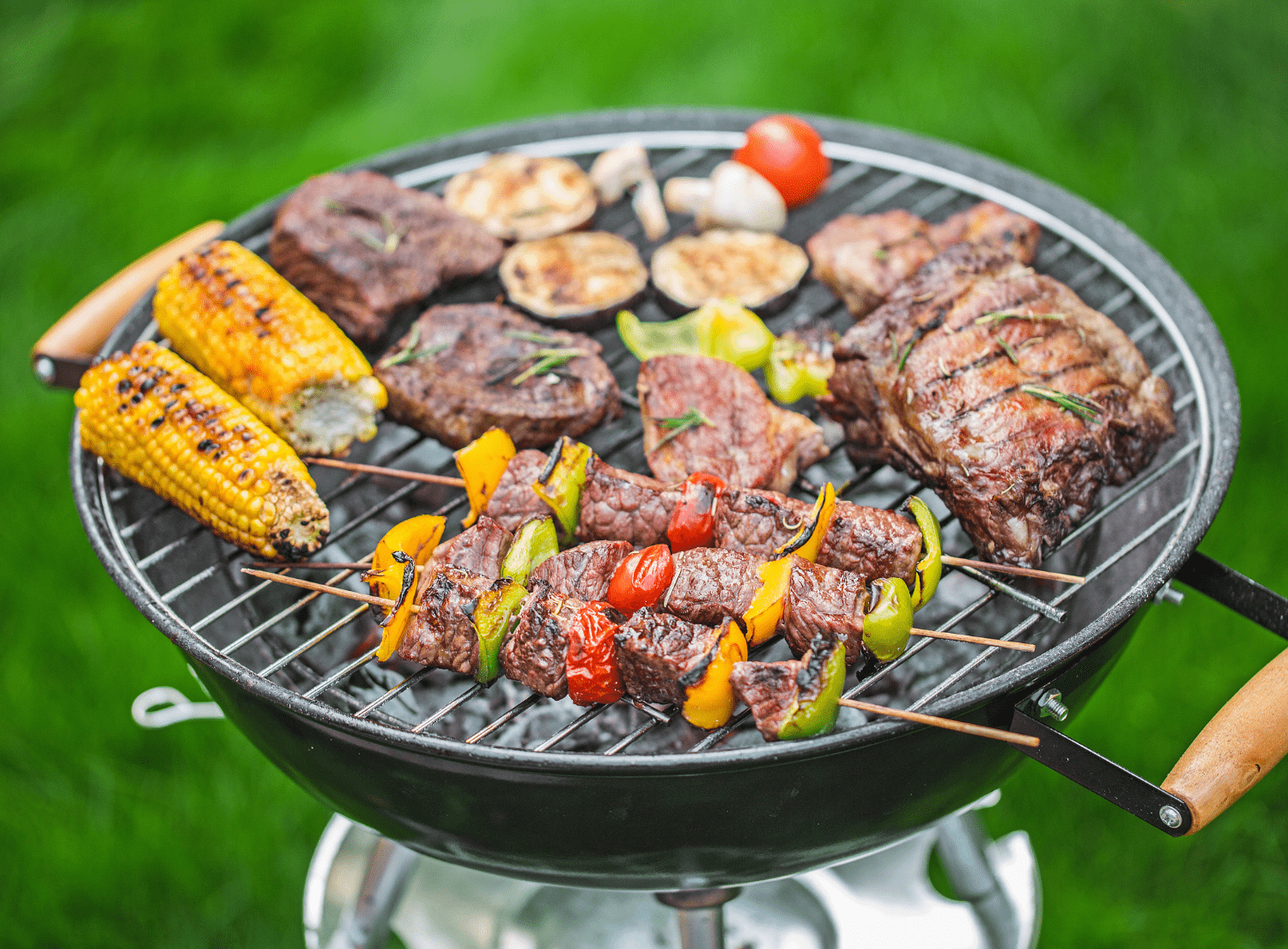various meats and vegetables being grilled on the BBQ