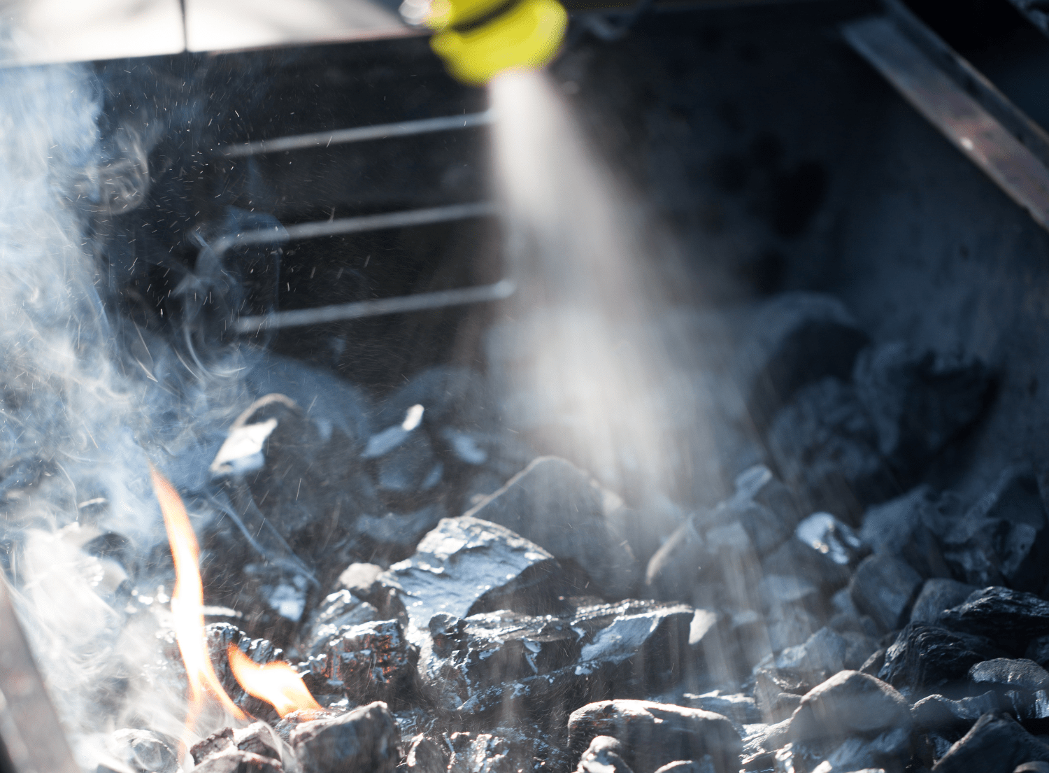lighter fluid being sprayed on open grill